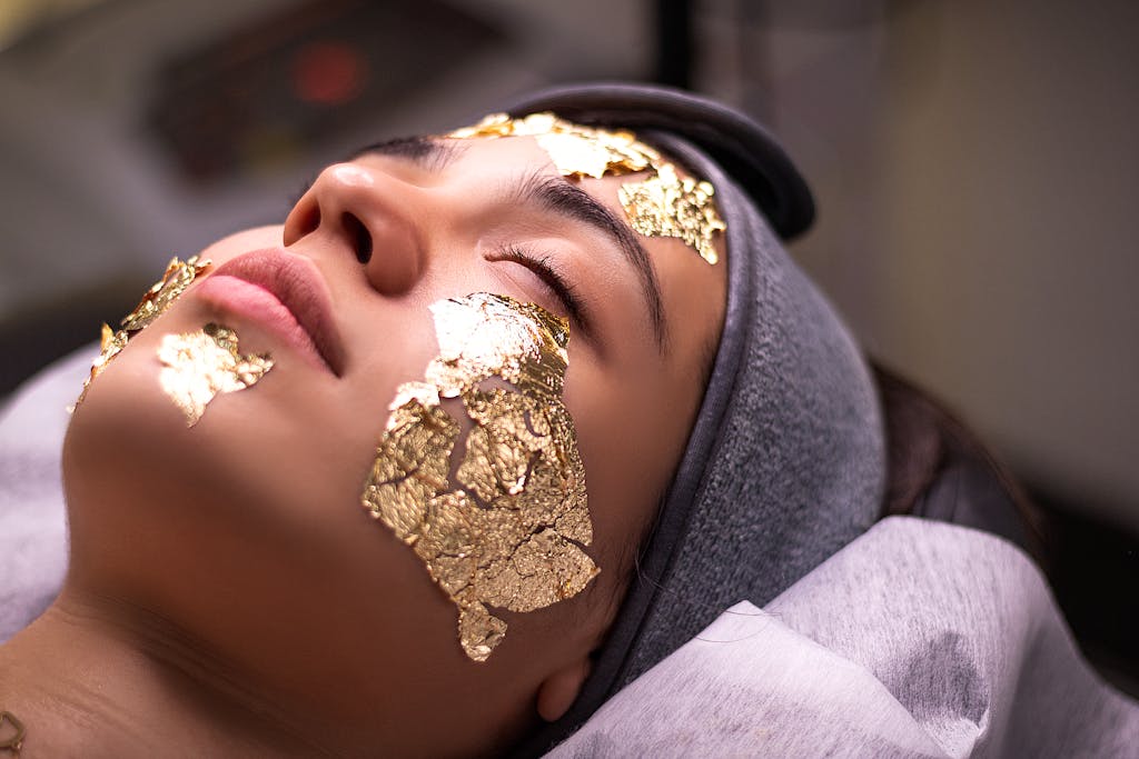 Relaxing spa experience with a gold leaf facial mask providing ultimate skincare luxury.